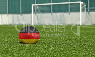 Soccer ball on the green field- flag Germany