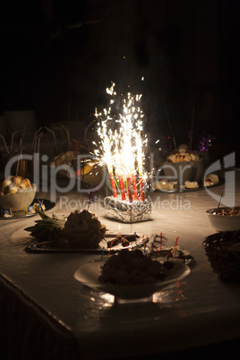 Burning sparkler on ice cream buffet