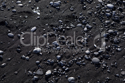 Stone structure at a black sand beach