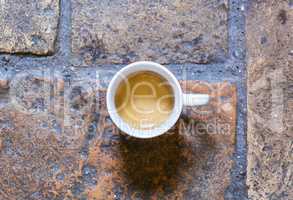 cup of coffee on a rustic floor