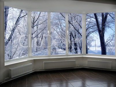 windows with view of winter road with trees in hoarfrost
