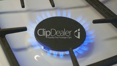 One gas burners burn blue flame on a gas stove