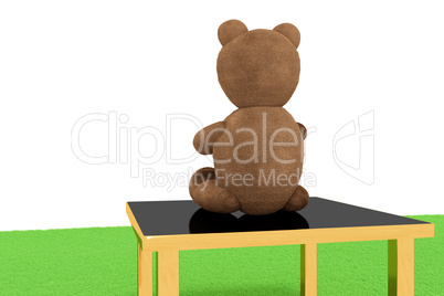 Teddy bear sits on the stool and looks into the distance