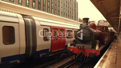 Steam Train London Underground Facing a Modern Train