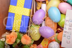 Arrangement of Gift Boxes in Wrapping Paper with Checkered Ribbons and Decorated Easter Eggs isolated on white background