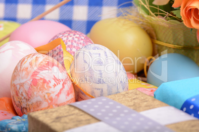 Arrangement of Gift Boxes in Wrapping Paper with Checkered Ribbons and Decorated Easter Eggs isolated on white background