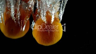 6 Tangerines Splashed into Water in Ultra Slow Motion - Black Background