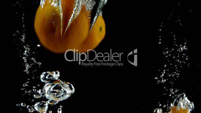 12 Tangerines Splashed into Water in Ultra Slow Motion- Black Background