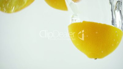 4 Sectioned Oranges Splashed into Water - Ultra Slowmotion