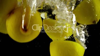 Whole and Sectioned Lemons Being Splashed into Water in Ultra Slowmotion