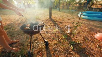 Ultra Wide Angle Shot of Young Lady Preparing Pork, Beef, Poultry and Chicken Barbecue (BBQ)