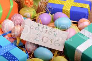 Arrangement of Gift Boxes in Wrapping Paper with Checkered Ribbons and Decorated Easter Eggs isolated on white background