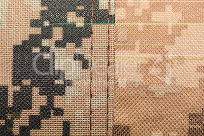 close up of worn out olive green tone camouflage fabric