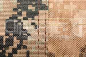 close up of worn out olive green tone camouflage fabric