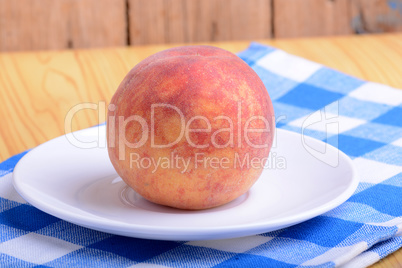 fresh peach on white plate
