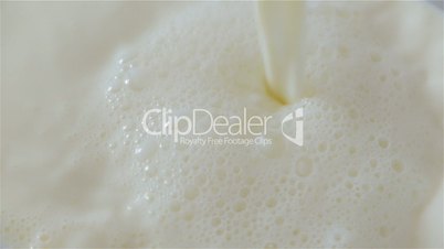 Close-up Shot of Milk Being Poured Over onto a Large Container