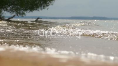 Look at the waves in the summer on the banks of the river Volga