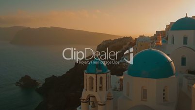 Establishing Wide Angle Shot of a Traditional Blue Dome Cycladic Church and the Aegean Sea