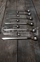 silver spoons arranged on the wood