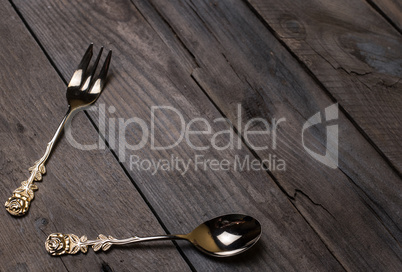 vintage forks and spoons on old wooden boards