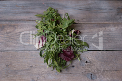 fresh rocket salad on wooden table
