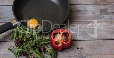 raw egg on the pan and salad