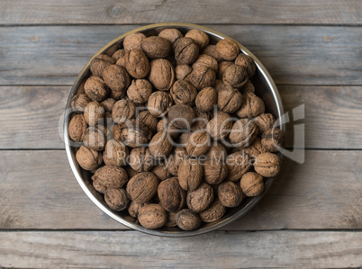 Walnuts in metal silver bowl