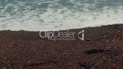 Slider Shot of Mediterranean Volcanic Beach with Red Sand and Human Footprints-Close-up