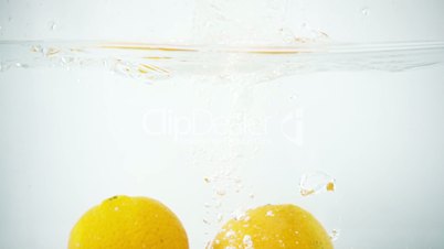 Two Tangerines Being Splashed into Water in Slow Motion