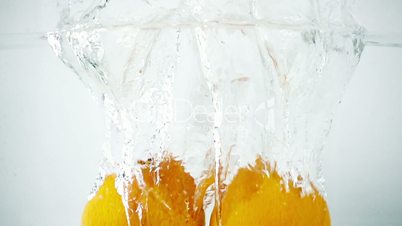 Two Tangerines Being Thrown into Water in Ultra Slow Motion