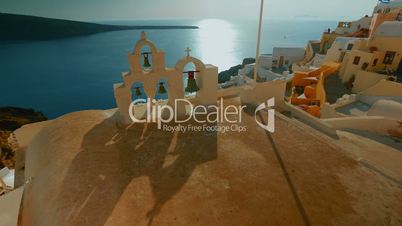 Inspirational Shot of Church Bells, Cycladic Houses and the Aegean Sea in Santorini Greece