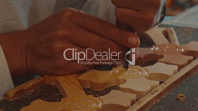 Craftsman Chiselling a Wooden Cross