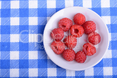 Big Pile of Fresh Raspberries in the White Bowl