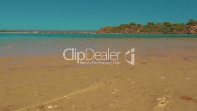 Low Angle Beach Shore Shot Turquoise Water in the Algarve, Portugal