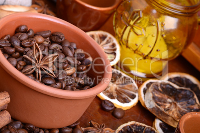 orange and lemon, coffee beans and cinnamon on wooden brown background.