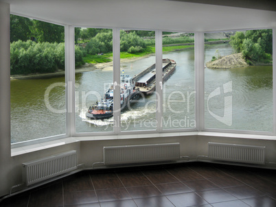 window with view of barge going on the river