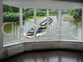 window with view of barge going on the river