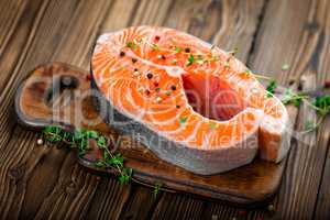 raw salmon fish steak on wooden rustic background