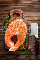 raw salmon fish steak on wooden rustic background