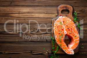 raw salmon fish steak on wooden rustic background