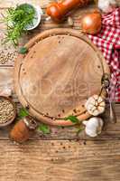 culinary background with empty cutting board and spices on wooden table