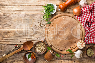 culinary background with empty cutting board and spices on wooden table