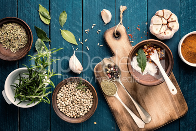 culinary background with spices on wooden table