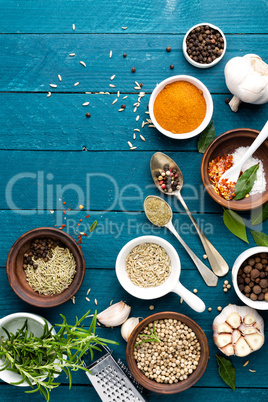 culinary background with spices on wooden table