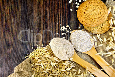 Flour and bran oat in spoon with grains on board