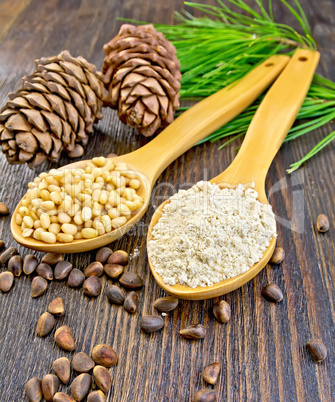 Flour and nuts cedar in spoon on board