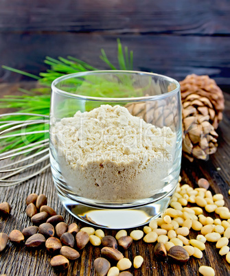 Flour cedar in glass with nuts on board