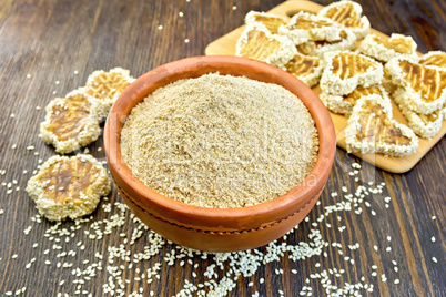 Flour sesame in clay bowl with cookies on board