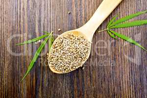 Hemp grain in spoon on board