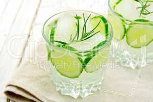 Lemonade with cucumber and rosemary in two glassful on beige nap